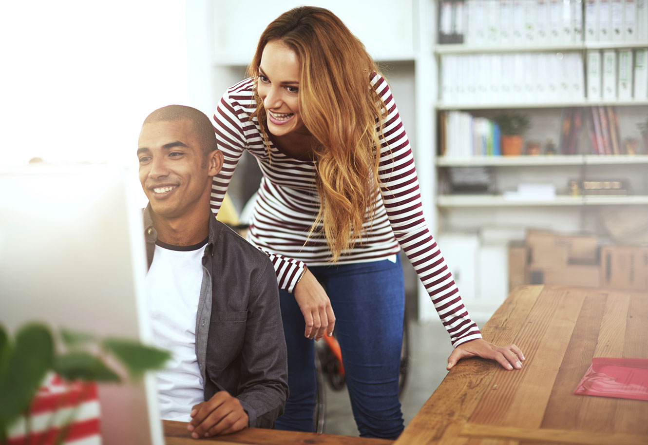 couple looking at their desktop computer screen