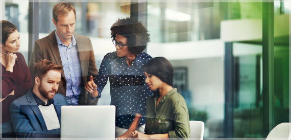 Small group of business coworkers have a discussion around a computer.